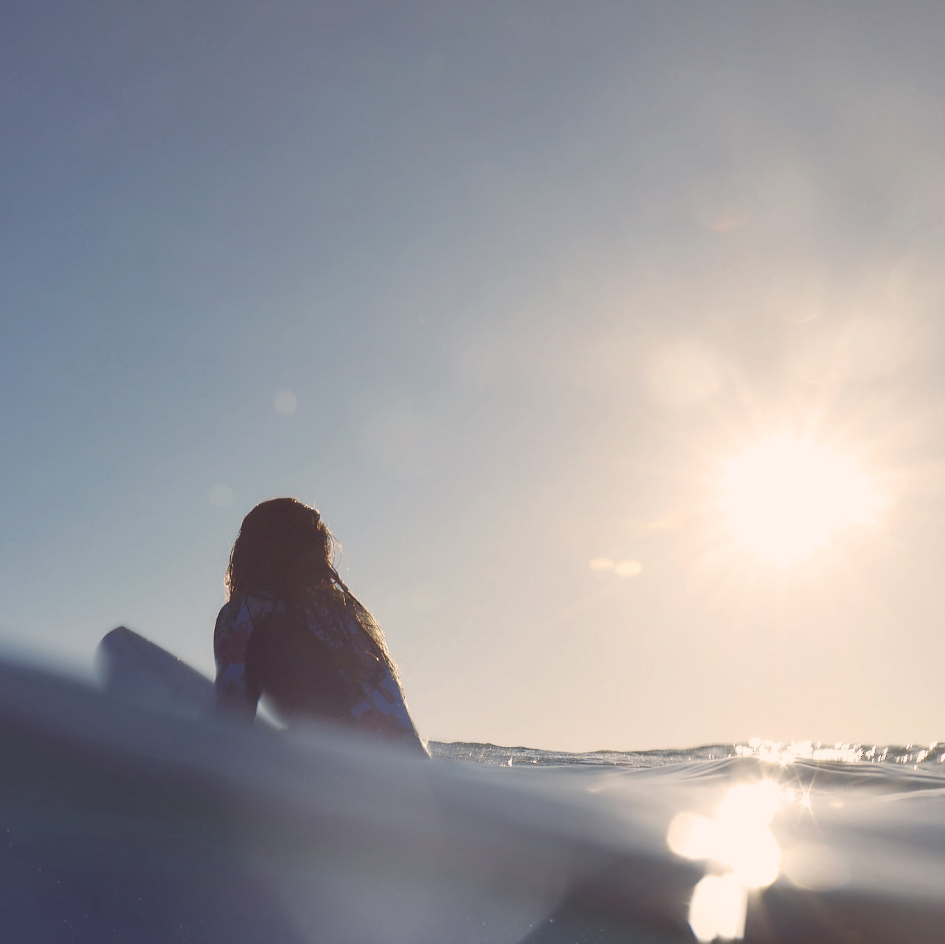 woman surfer in water on board in ocean