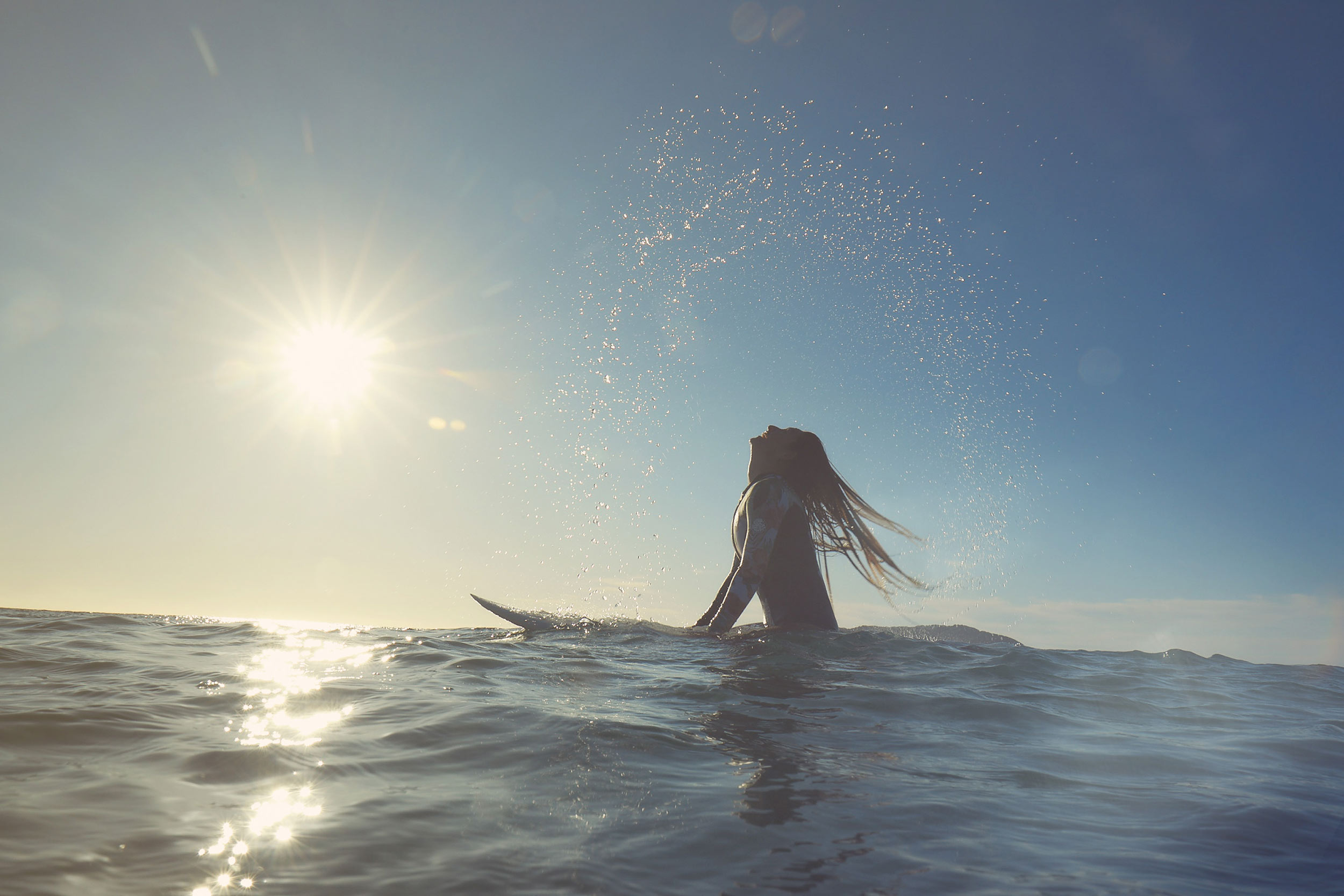 woman surfer on board in ocean