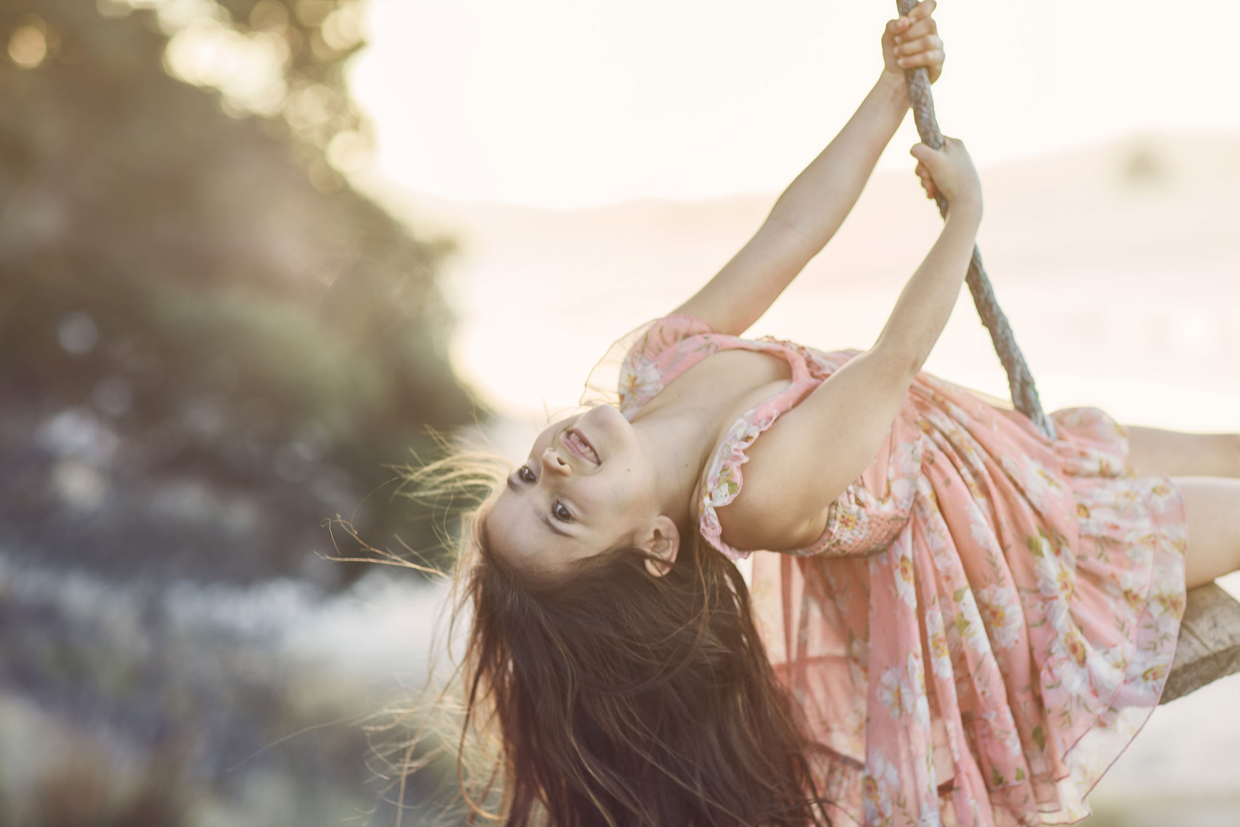 small girl on swing at beach