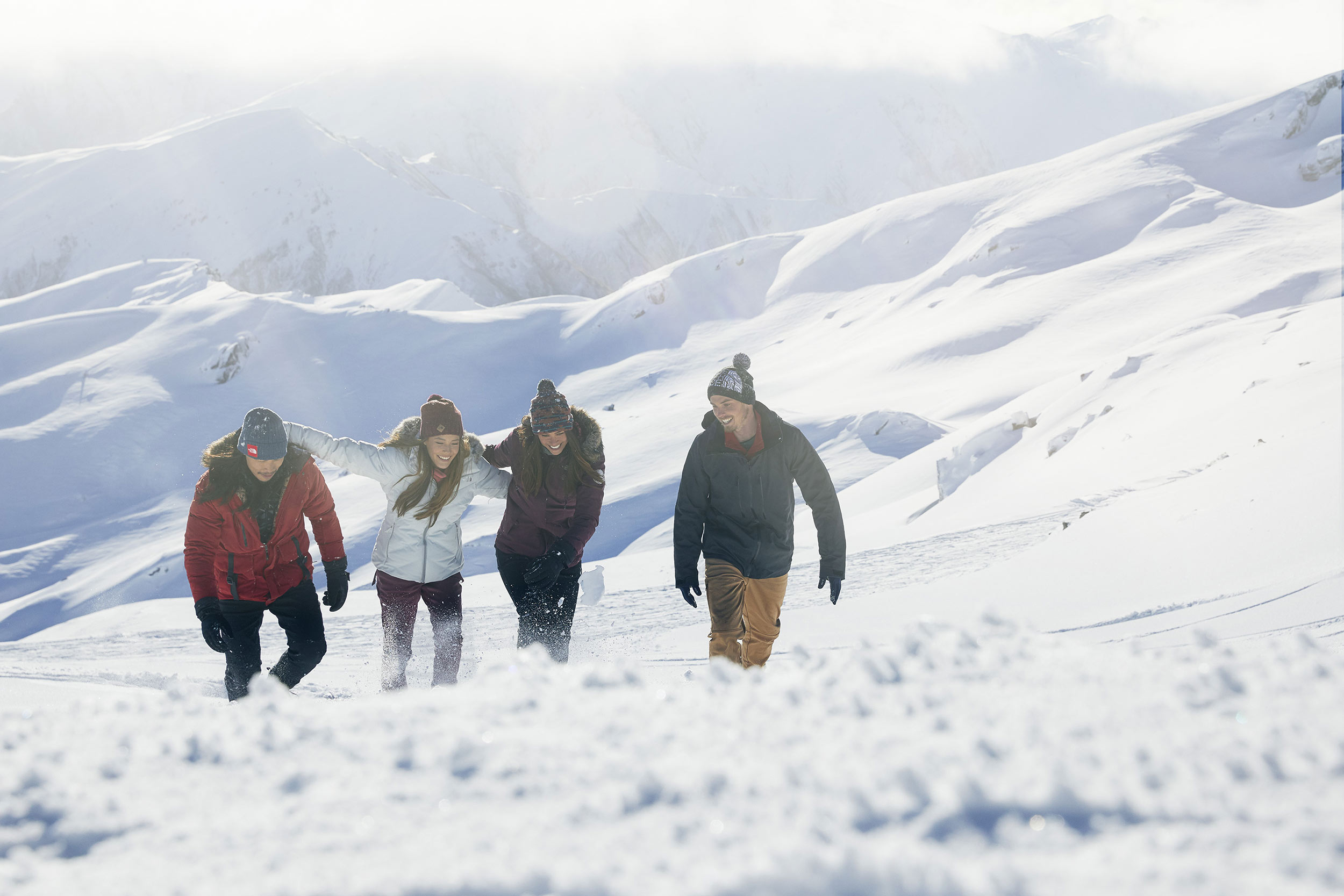 group walking up snow mountain north face nz
