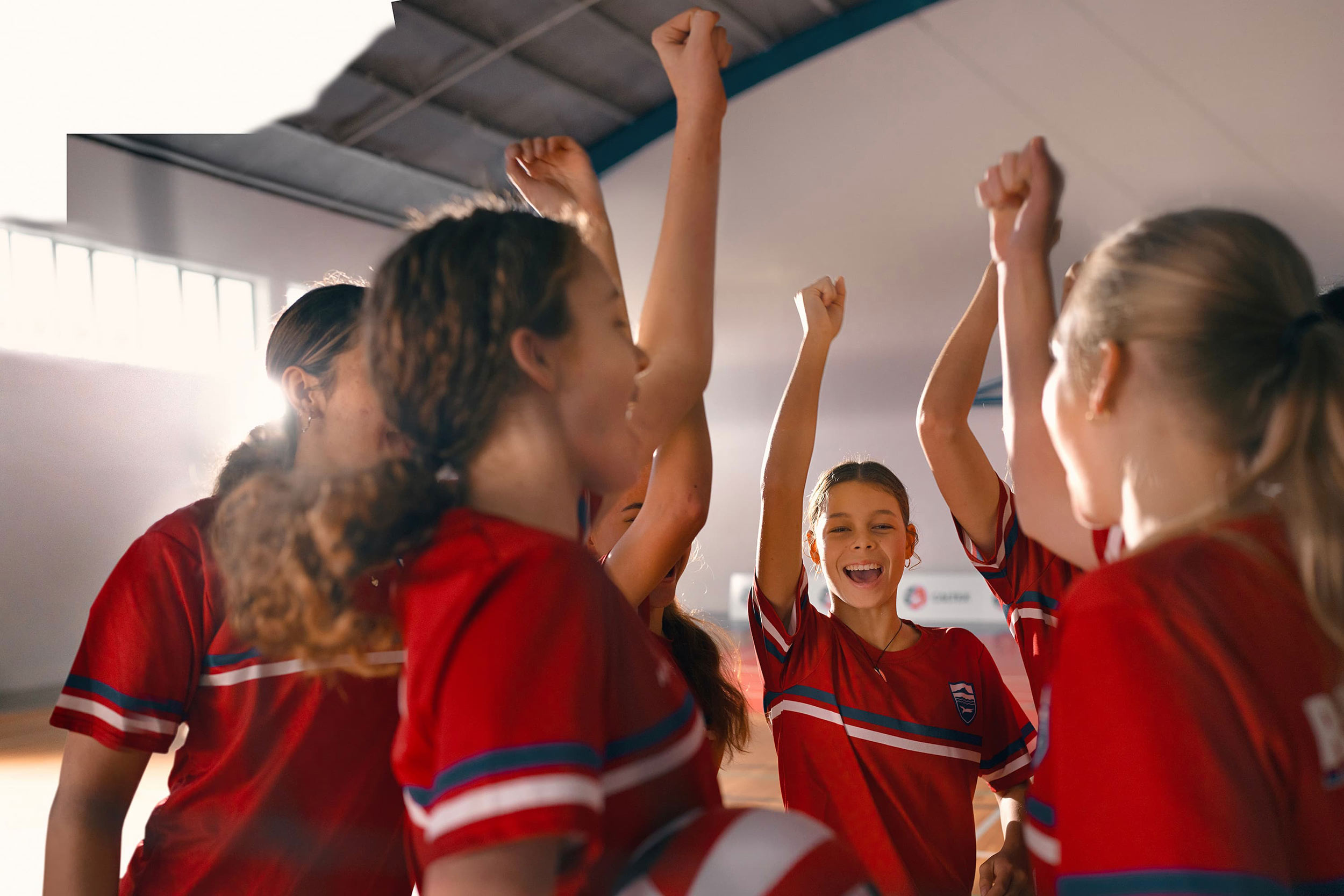 Girls cheering on Netball court Daniel Caltex